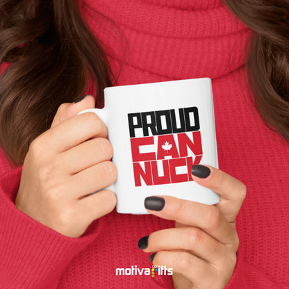 A woman holding a white 11oz ceramic mug that reads in black/red bold Proud Canuck art printed on both sides
