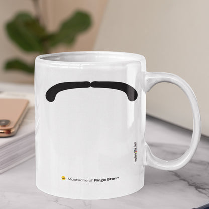 White ceramic mug with a drawing of Ringo Starr mustache featuring a marble table.