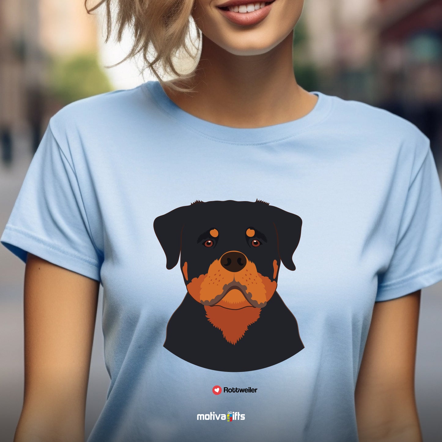 Woman wearing light blue tshirt with Rottweiler design on the front, front view, by Motiva Gifts.