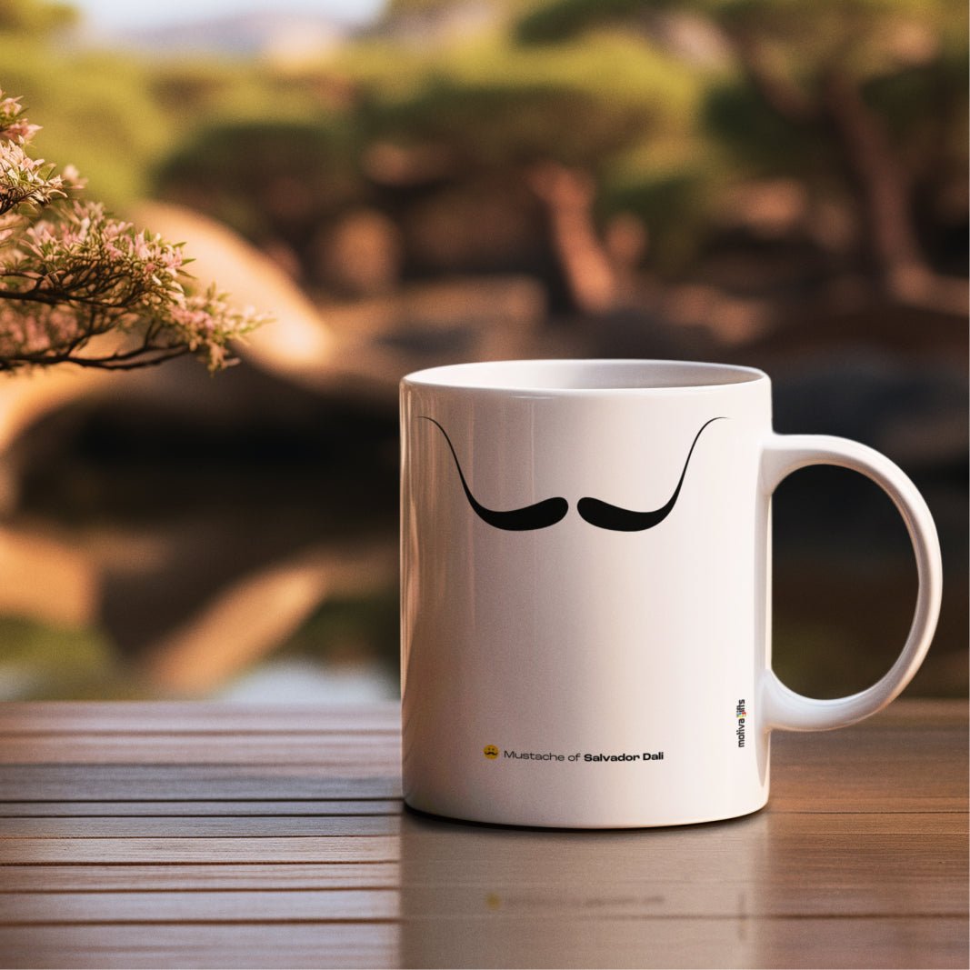 White ceramic mug with a drawing of Salvador Dali's mustache featuring a rustic table. 