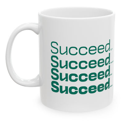 White ceramic mug with a white wraparound design and the word 'Succeed' printed in green in four typography styles: light, medium, bold, and black. Clean white background