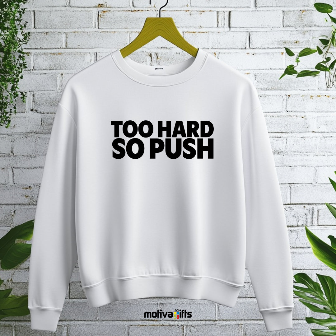 A hanging wearing a white flat-lay Sweatshirt with black typography that reads Too Hard So Push