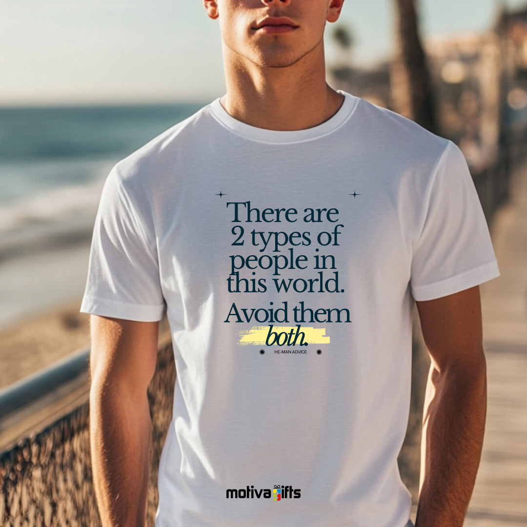 A man wearing a white T-shirt featuring bold black typography that reads There are two types of people in this world. Avoid them both. 