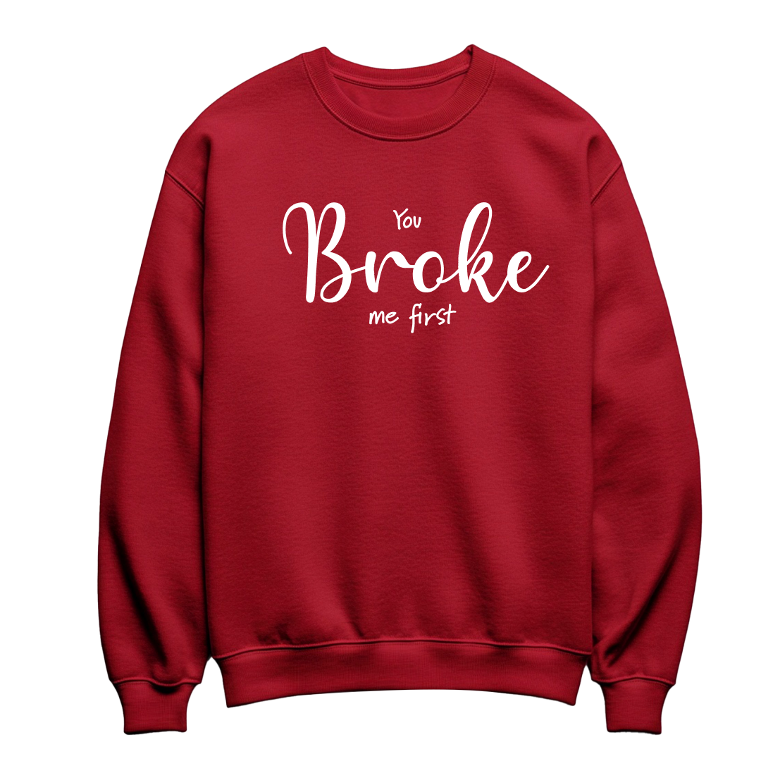 Red flat-lay Unisex Crewneck Sweatshirt featuring white typography that reads You Broke Me First 