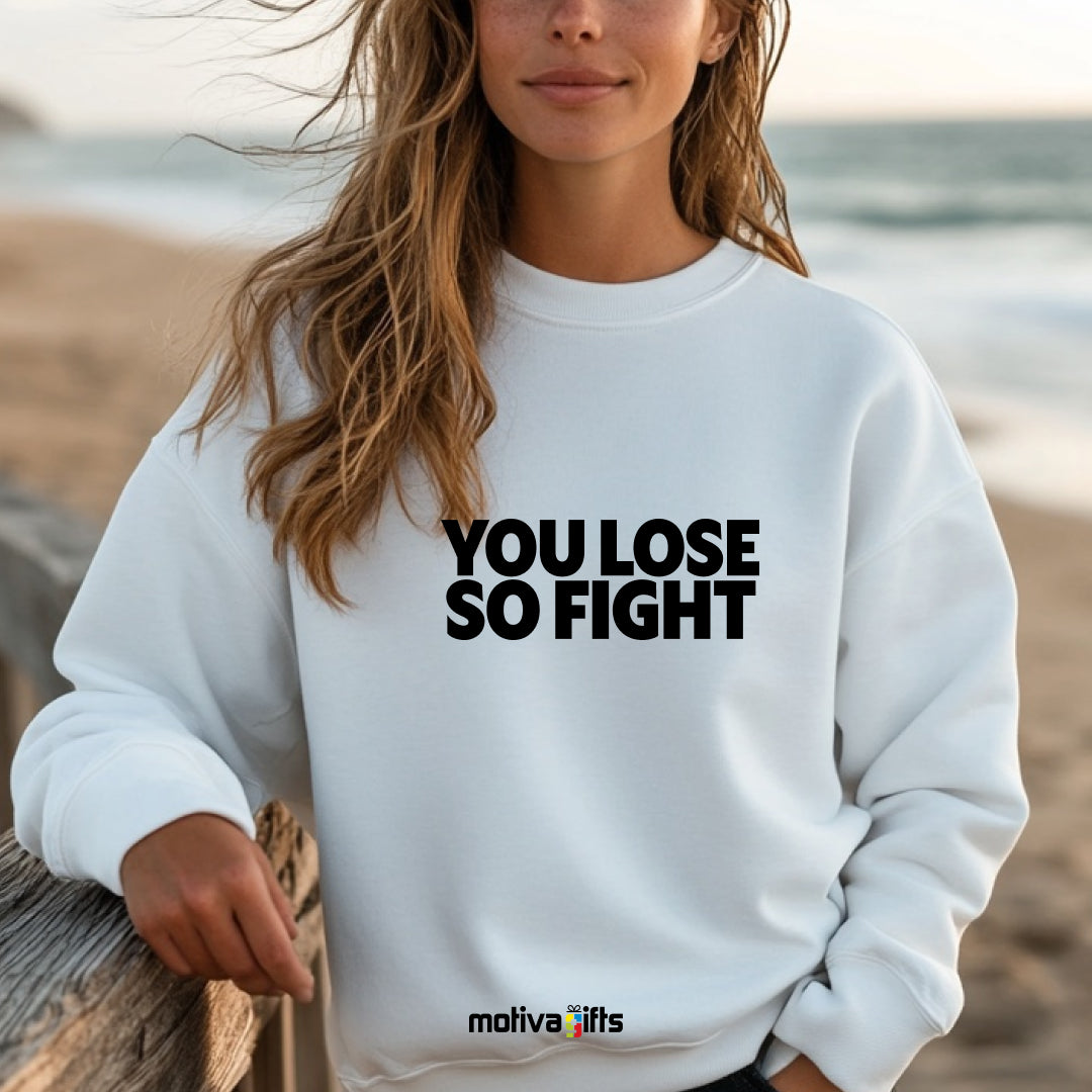 A woman wearing a white flat-lay Sweatshirt with black typography that reads You Lose So Fight