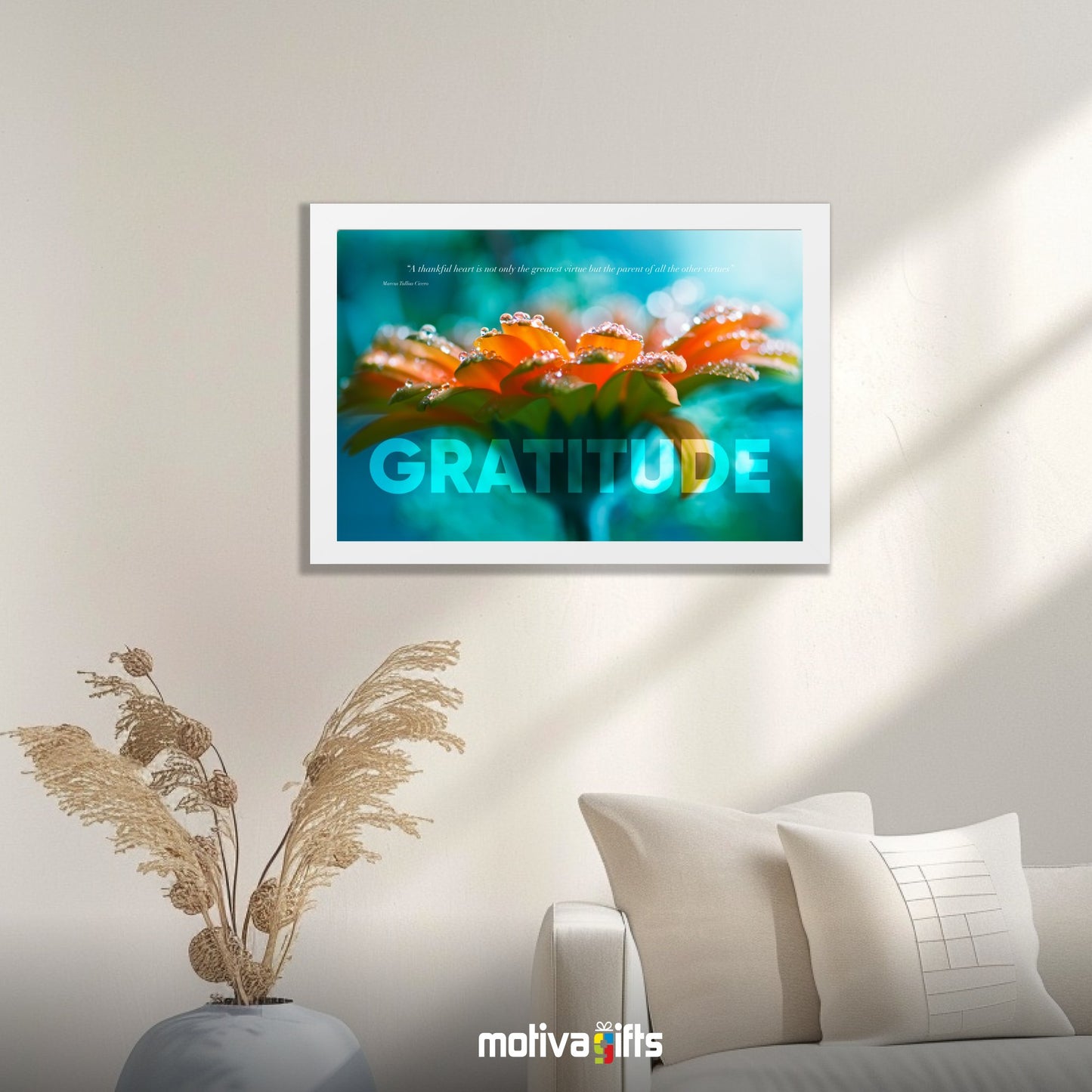 A white framed art wall with the word GRATITUDE in large text and a Cicero quote hangs in a modern living room. 